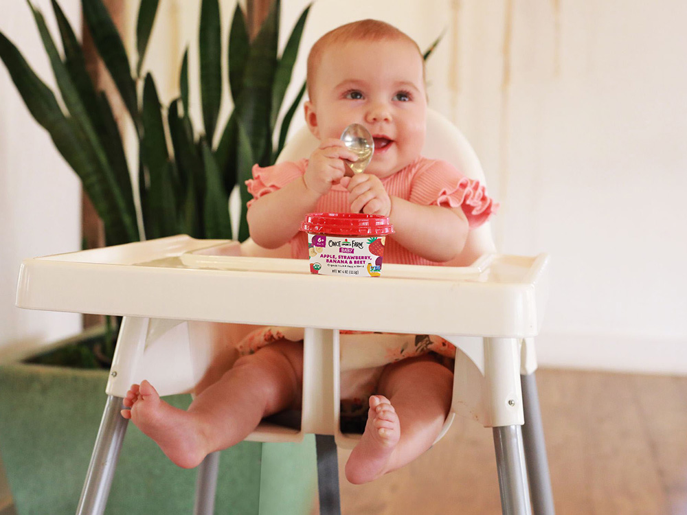 Photo of baby excited to eat Once Upon a Farm baby food