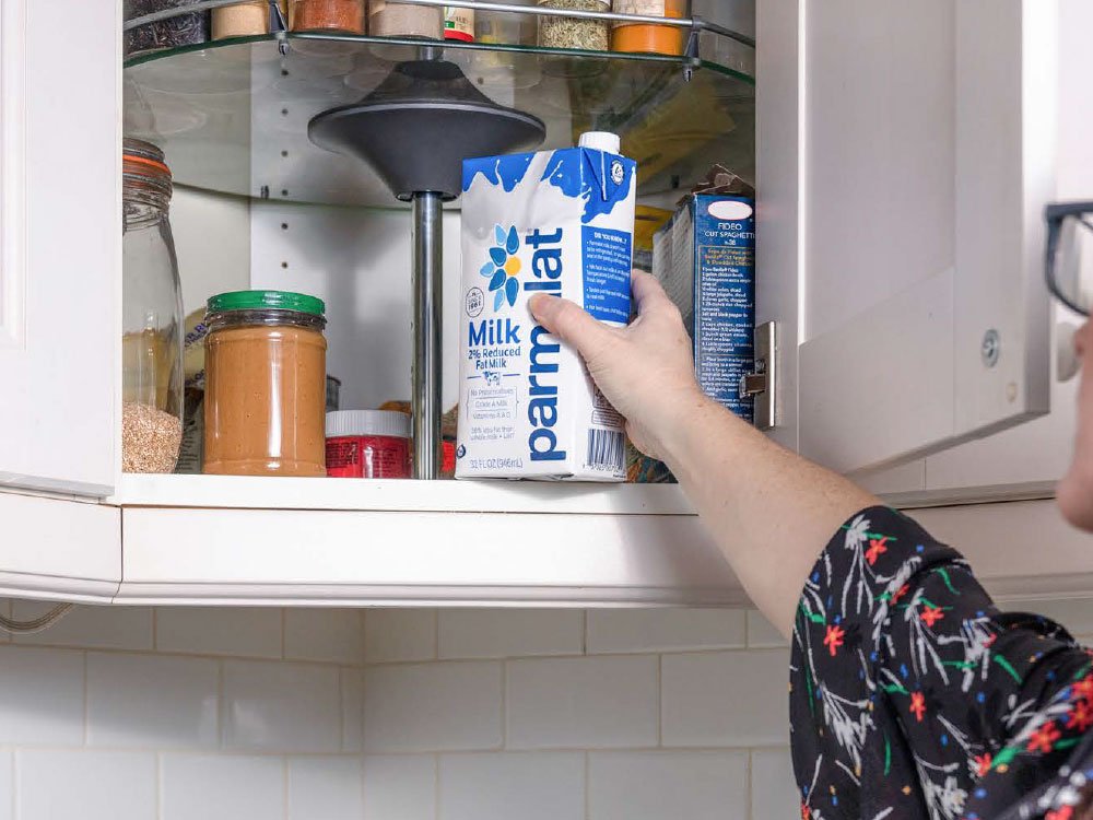 Photo of individual reaching into pantry for a carton of Parmalat milk