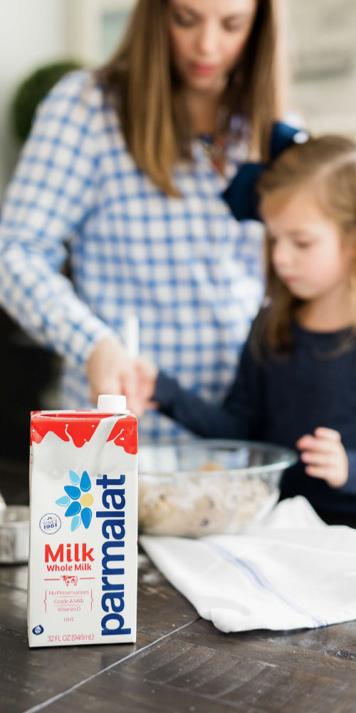 Photo of mother and daughter baking with Parmalat milk featured in foreground