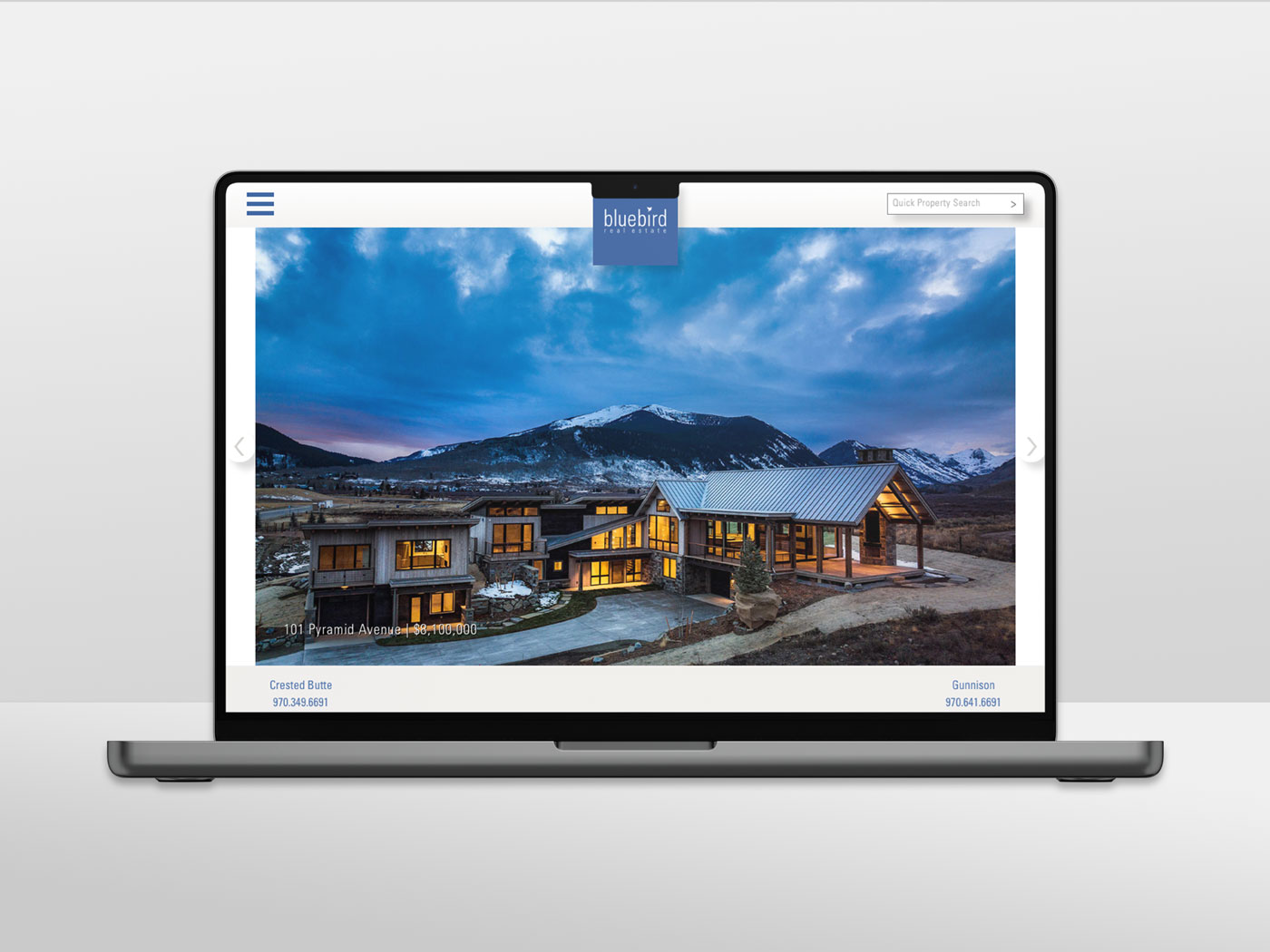 MacBook Pro mockup featuring a screenshot of BlueBird Real Estate website